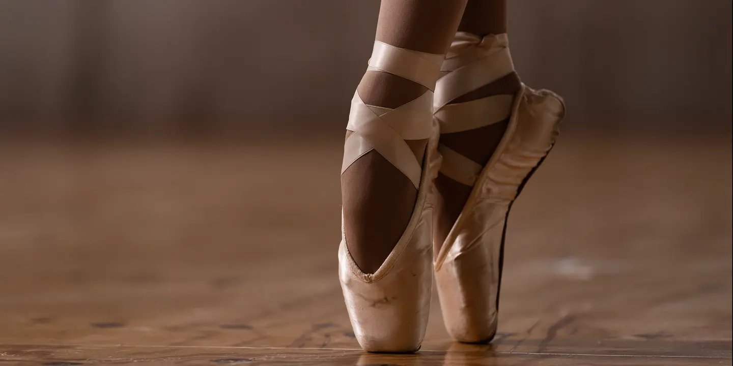 Close-up of a ballerina's feet in ballet shoes. 
