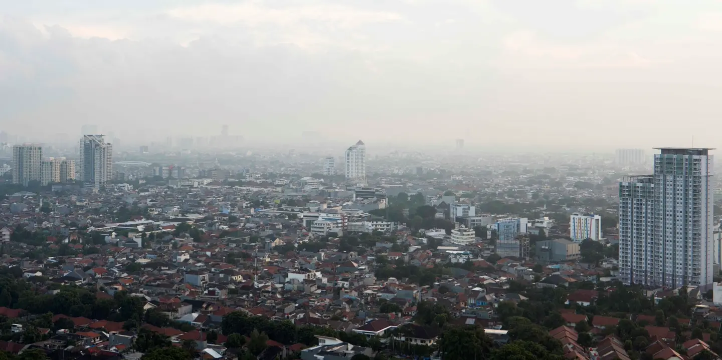 View of a foggy city with tower blocks.
