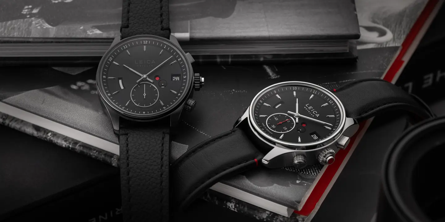 Two Leica Monochrom watches on a pile of books.