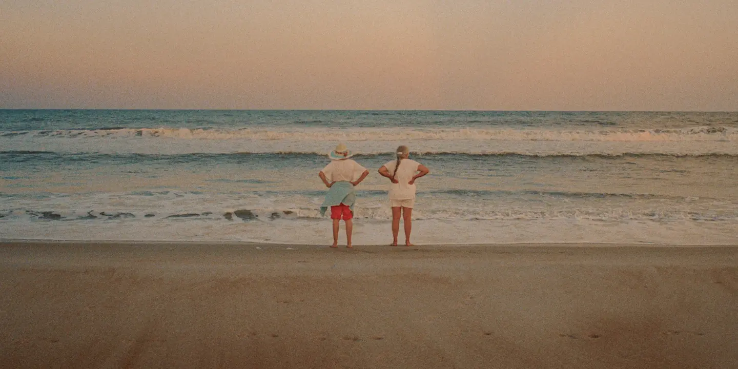 Couple standing on the beach and looking out to sea