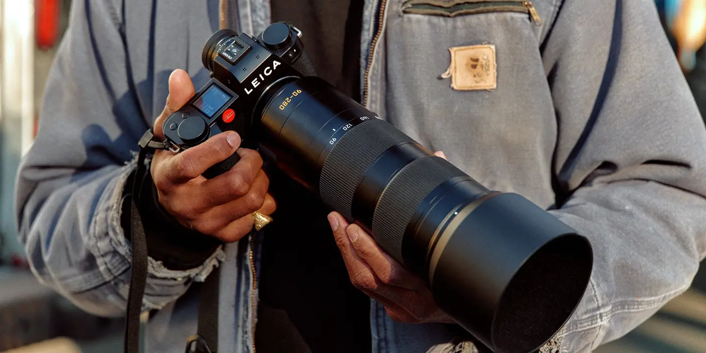 A man holding a Leica camera in his hand