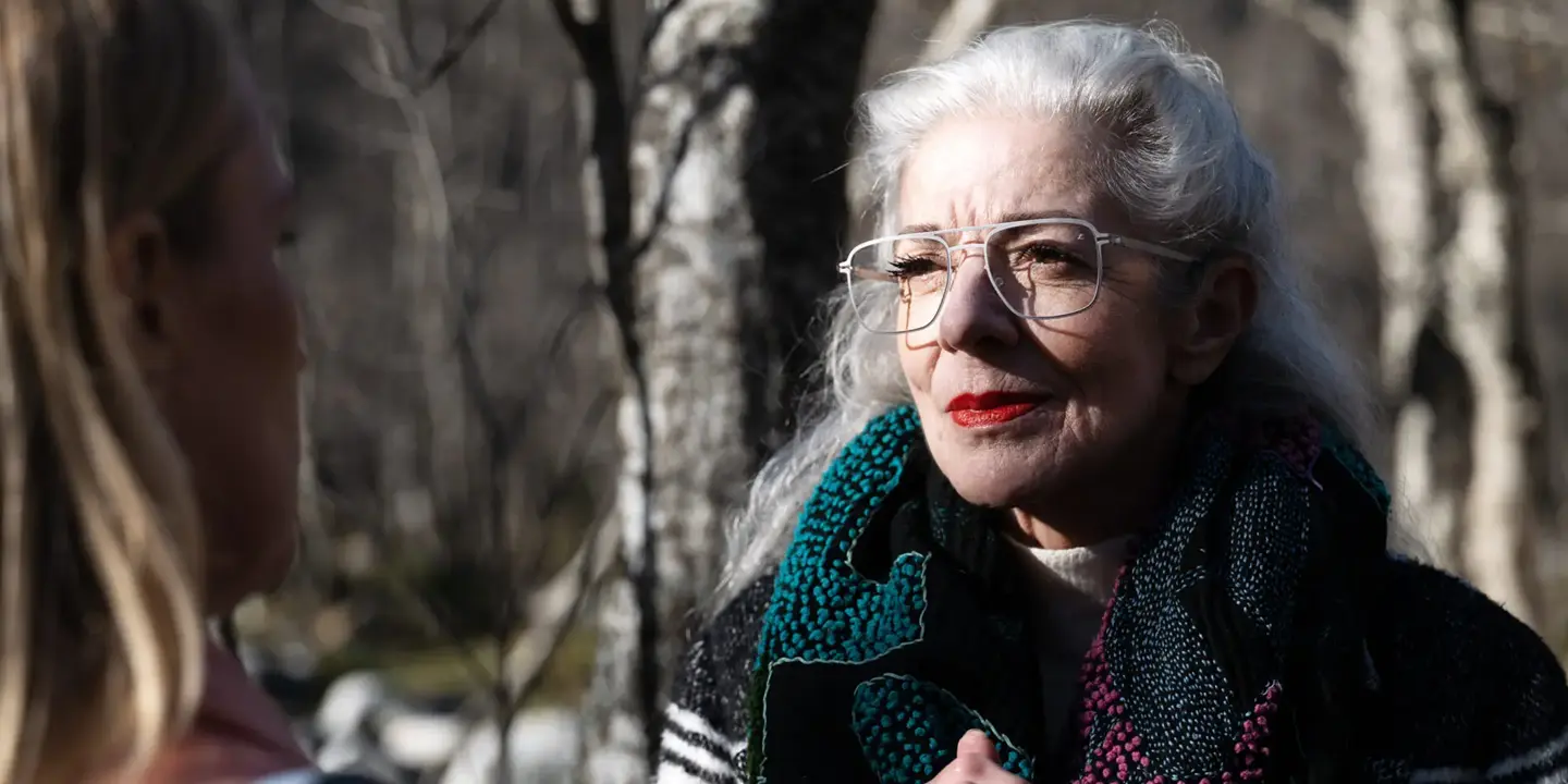 an elderly woman wearing glasses with Leica lenses