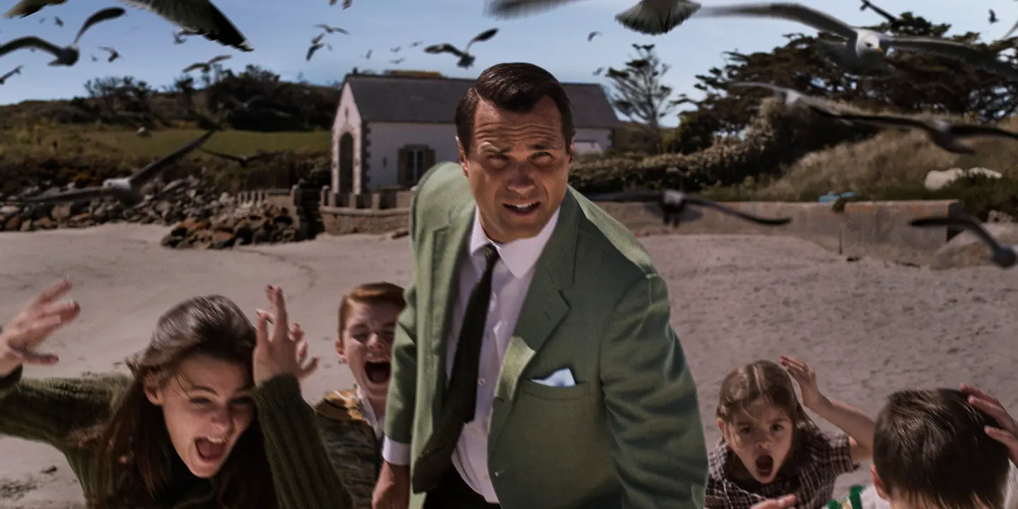 A man and five kids running away from crows 