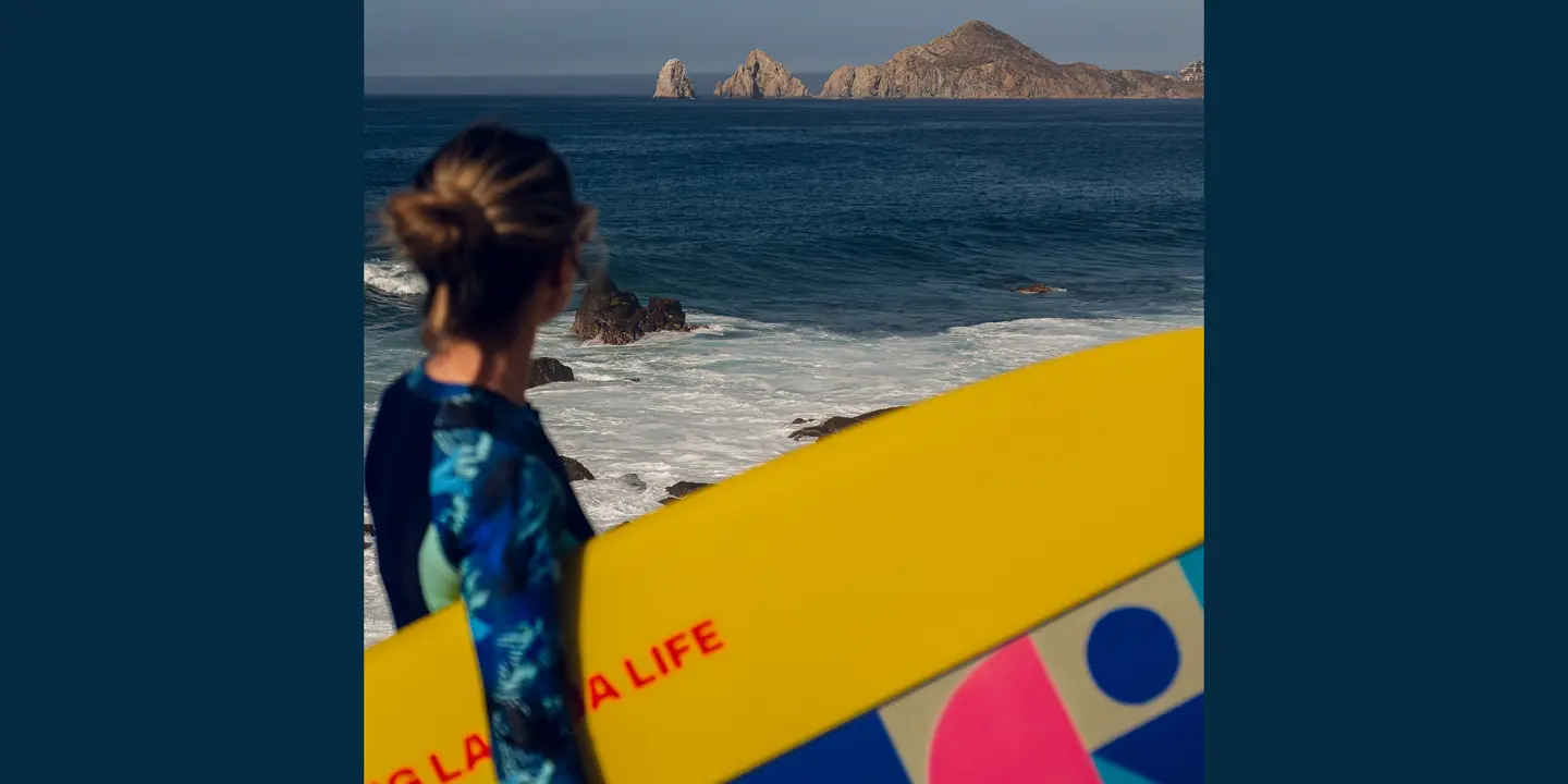 Woman with a surfboard under her arm
