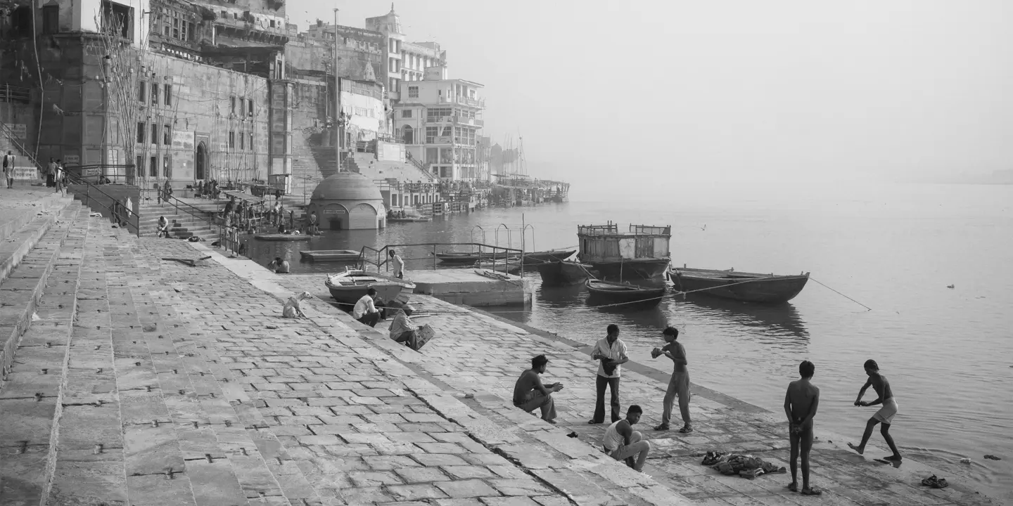 Black-and-white photo of people at a harbour in India