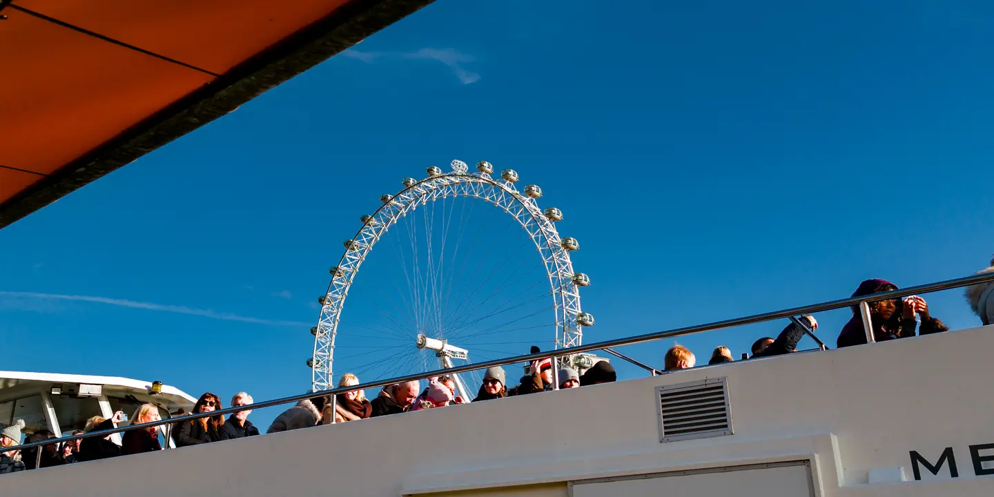 A boat trip on the River Thames in London, with the Ferris wheel visible in the background
