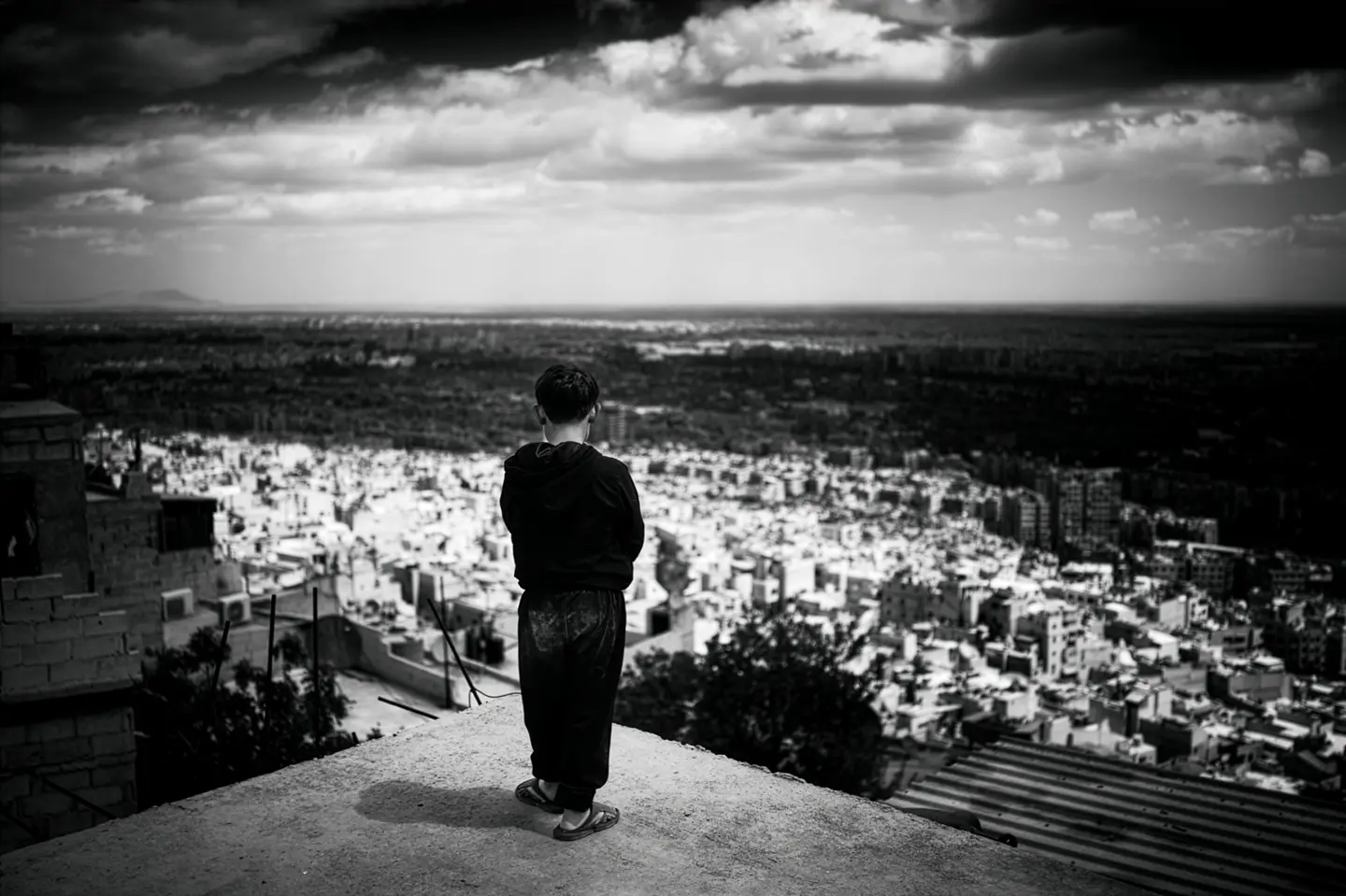 A boy overlooking a city