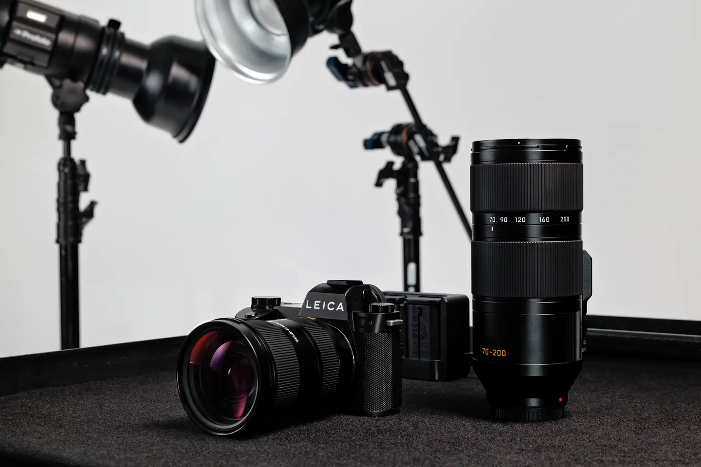 Leica SL3-P with Vario-Elmarit-SL 24-70 on a table next to the Vario-Elmarit-SL 70-200