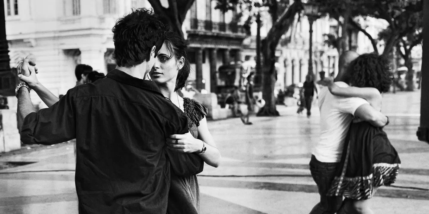 Couples dancing tango on Paseo del Prado in Havana, Cuba, captured in expressive black-and-white street photography.