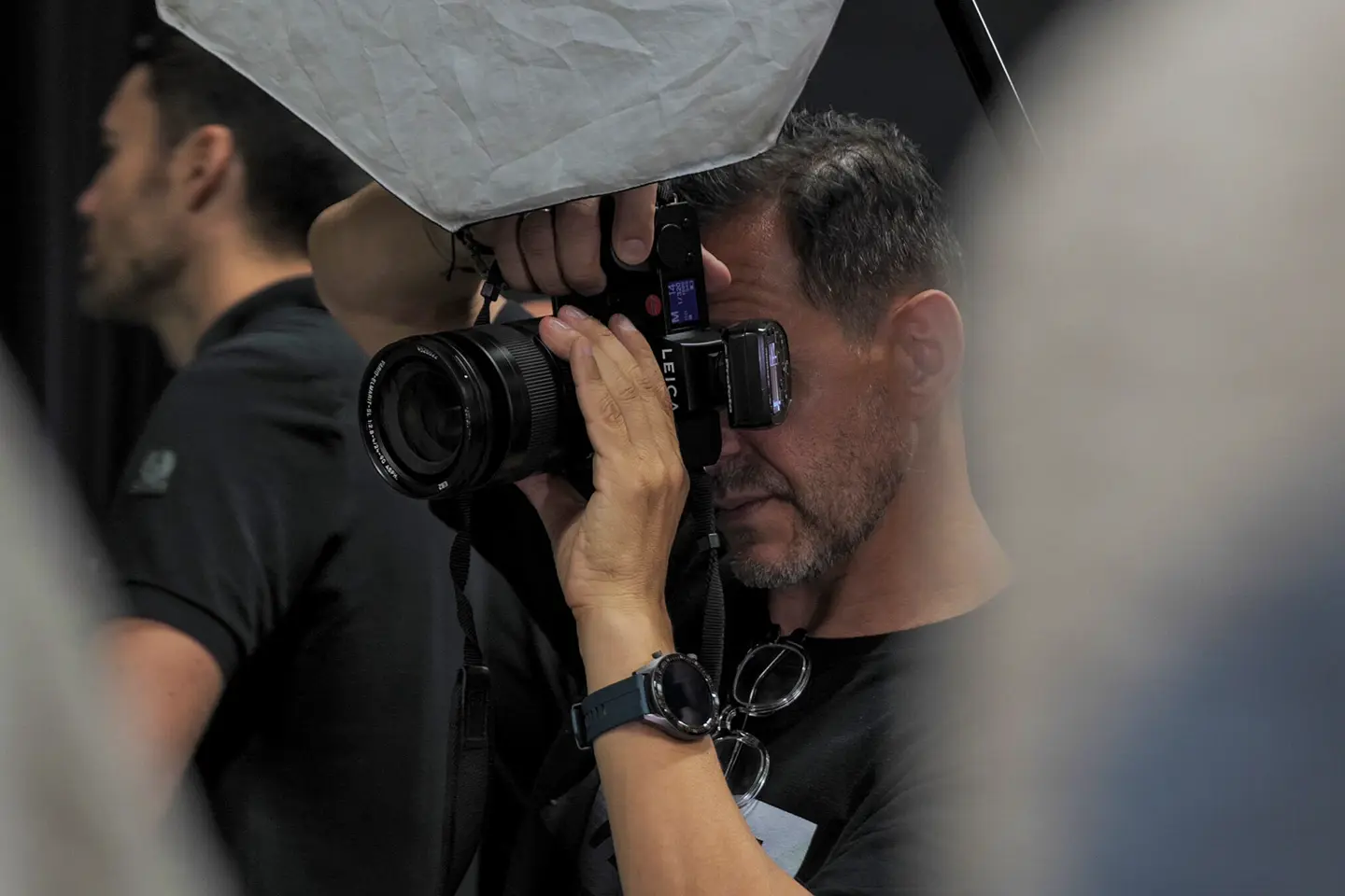 Close-up of a man taking a picture in a studio.