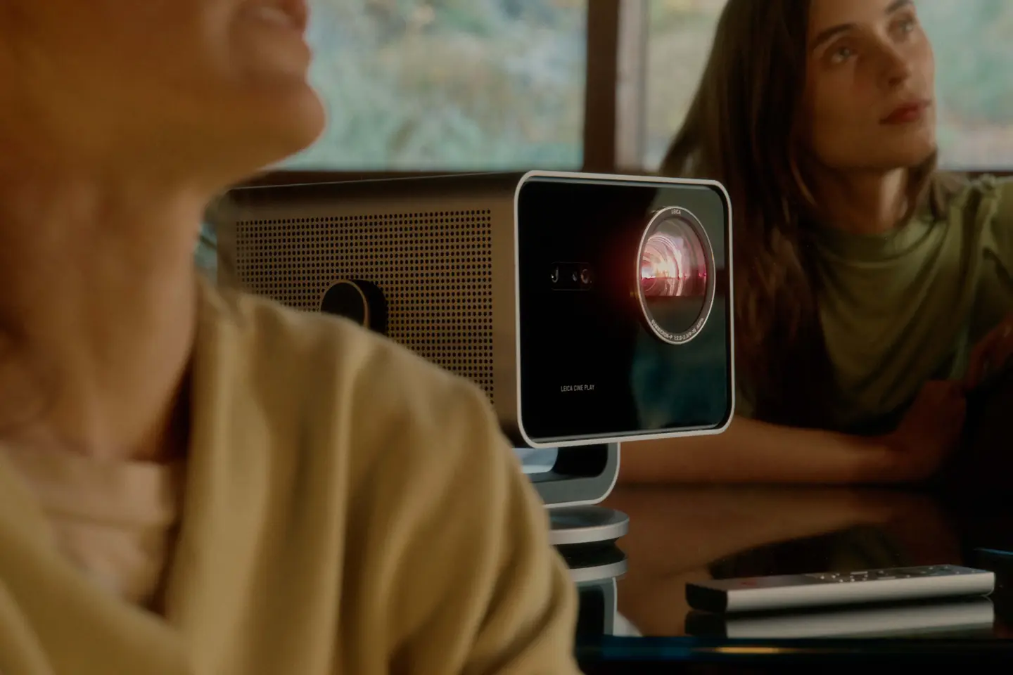 Two women sitting beside the Leica Cine Play 1.