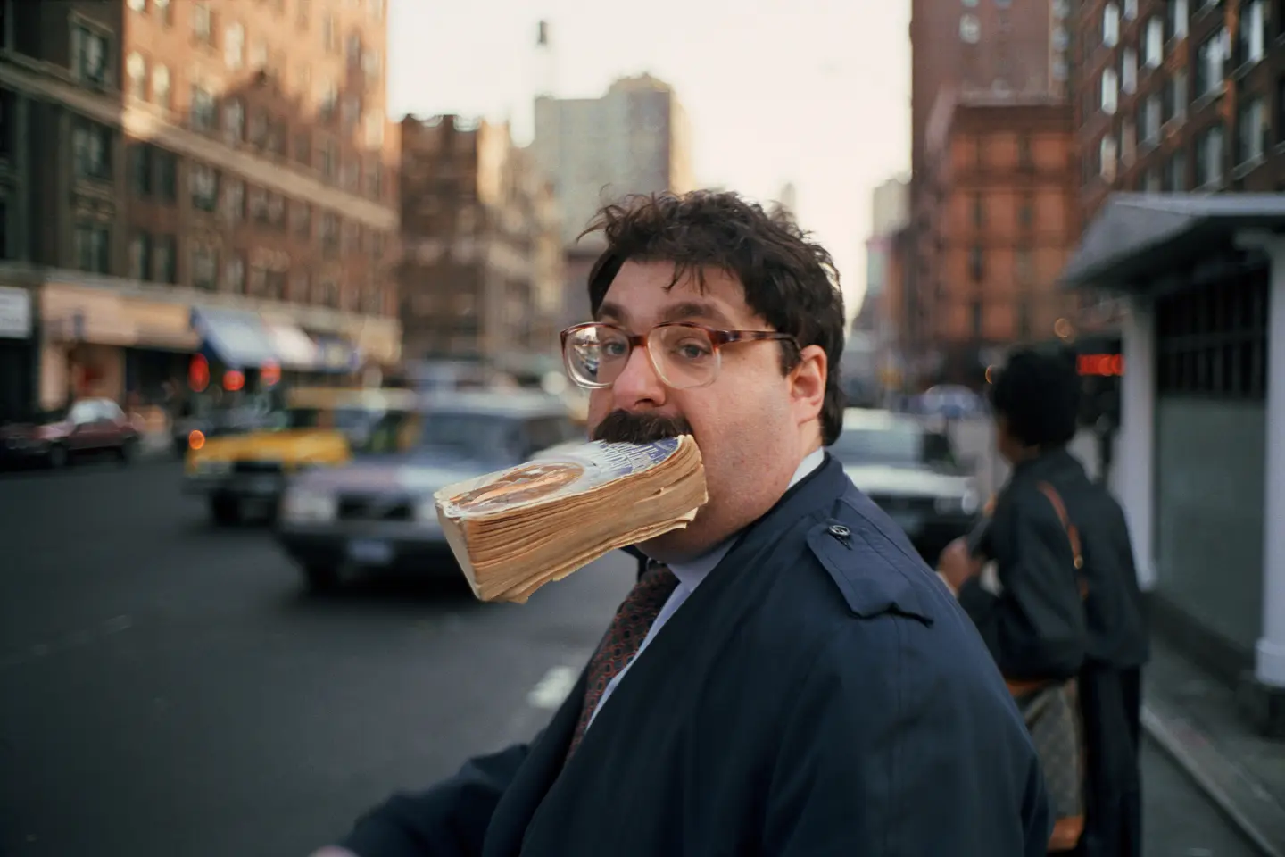Man with a book in his mouth