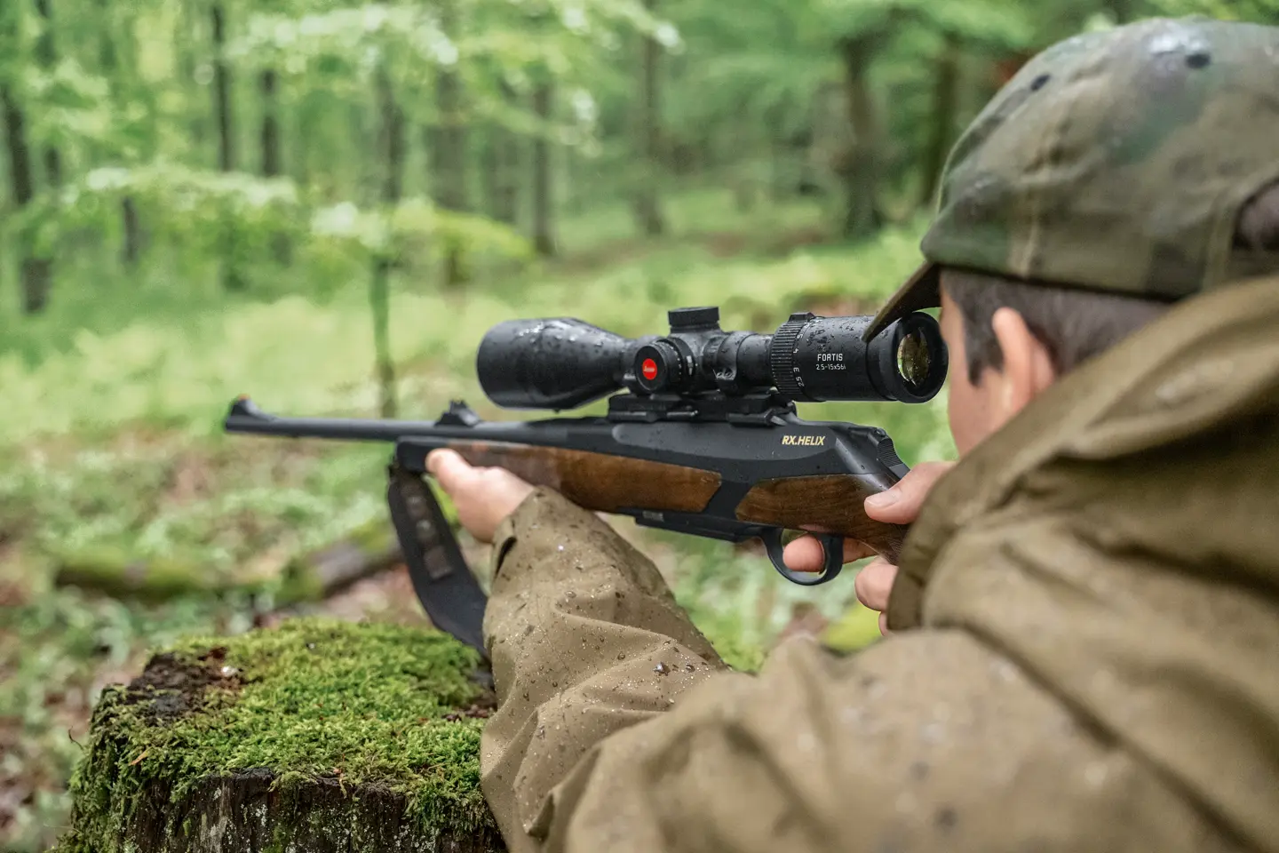 Hunter is aiming with his rifle and his Leica Fortis