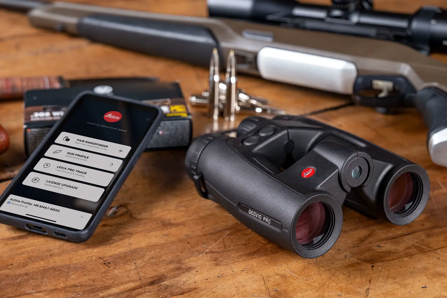 leica-hunting-binoculars-geovid-pro-on-wooden-table-connected-smartphone-leica-app