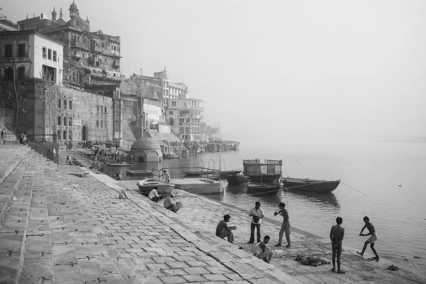 Black-and-white photo of people at a harbour in India