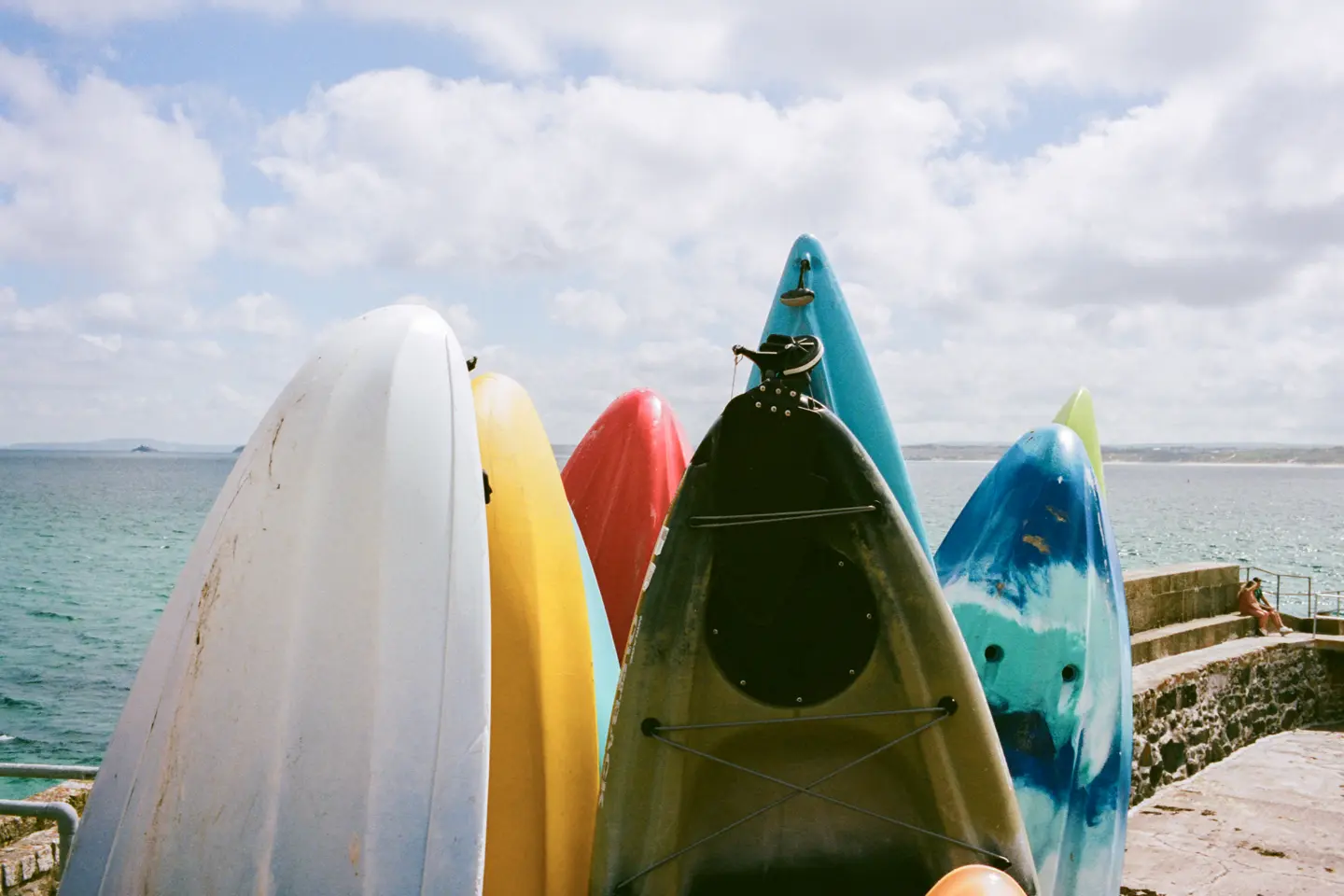 Colour image of surfboards by the seaside.