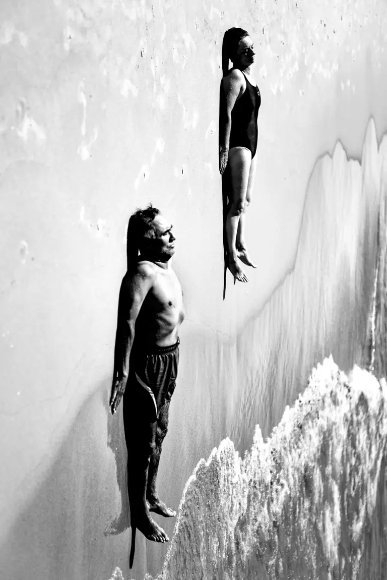 people lying on the beach black and white