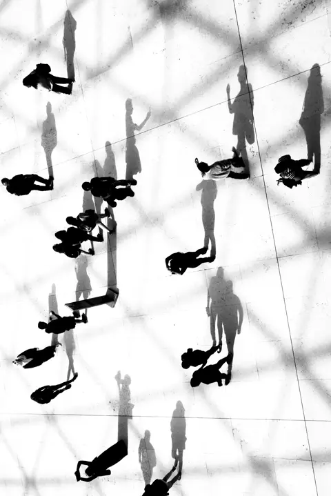 crowd and shadows black and white