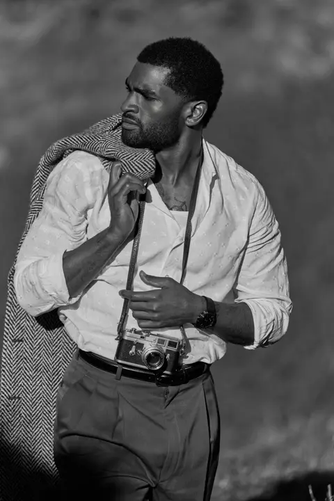 black and white photo of a man with his leica camera