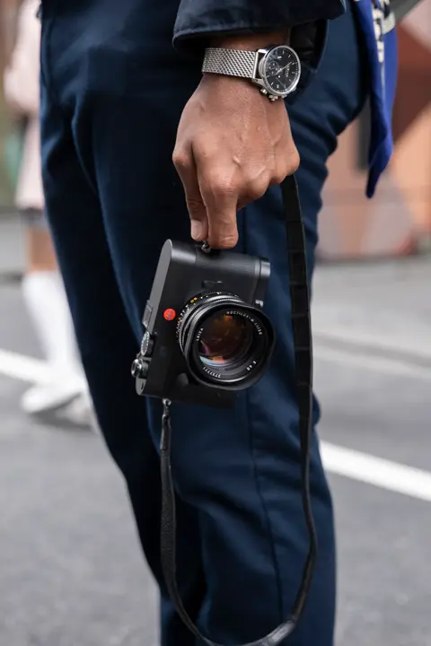 Man holding a Leica M EV1 camera in his hand