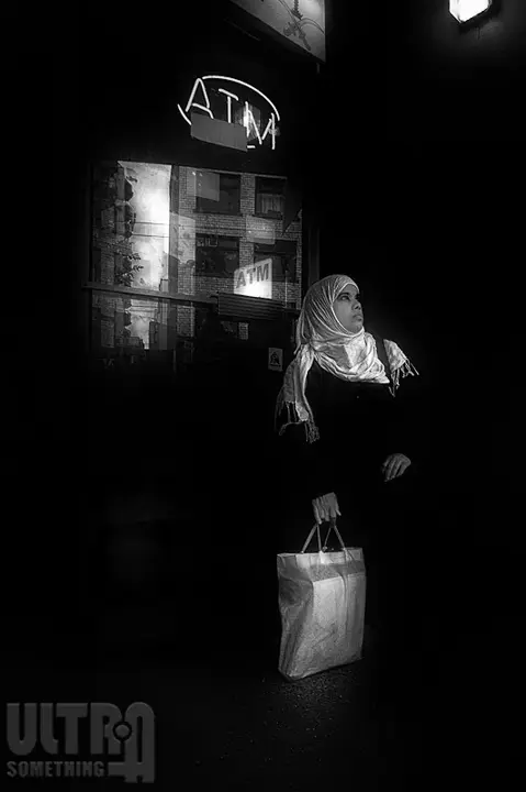 women with veil standing in front of sign B&W