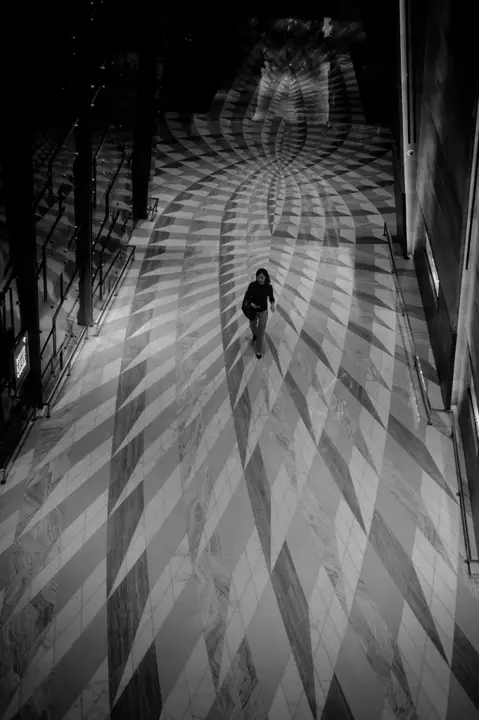mural floor and woman walking b&w