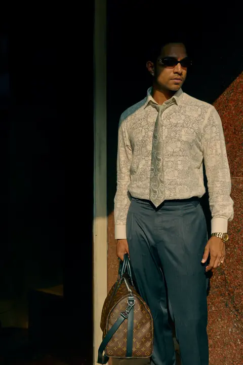 Man Model with sunglases and a bag