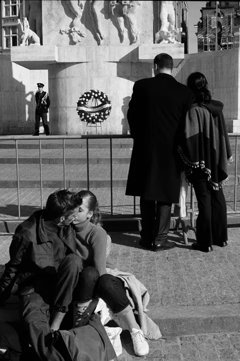Black-and-white photograph of a couple kissing