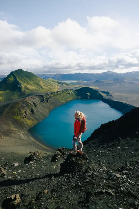 Asa Steinars in the mountains of iceland, infront a lake