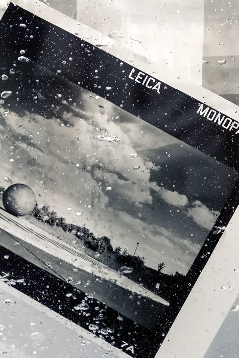 Leica MONOPAN 50 black-and-white print covered with water droplets.