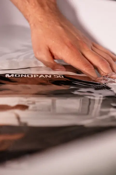 Hand washing a Leica MONOPAN 50 photographic print in water.