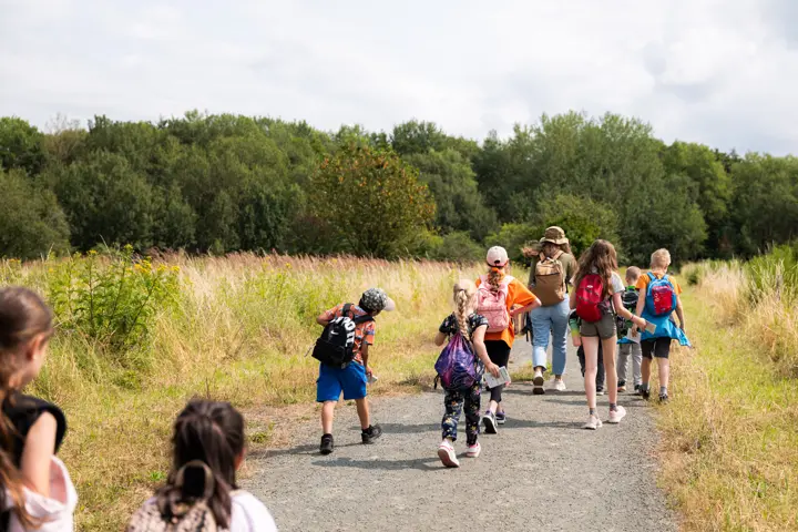 Children running along a country road.