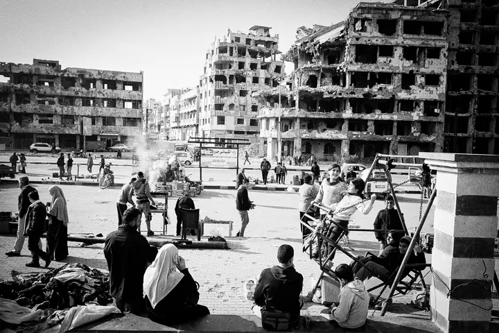 Syria after the fall of the regime in 2024. Many people in front of old ruins