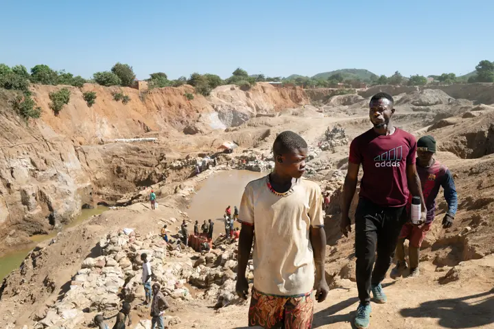 Three men walking through the desert.