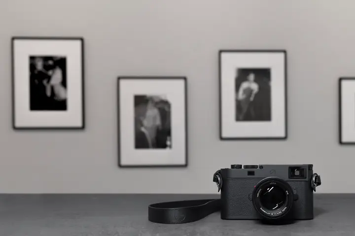 Leica M11 in front of framed photographs