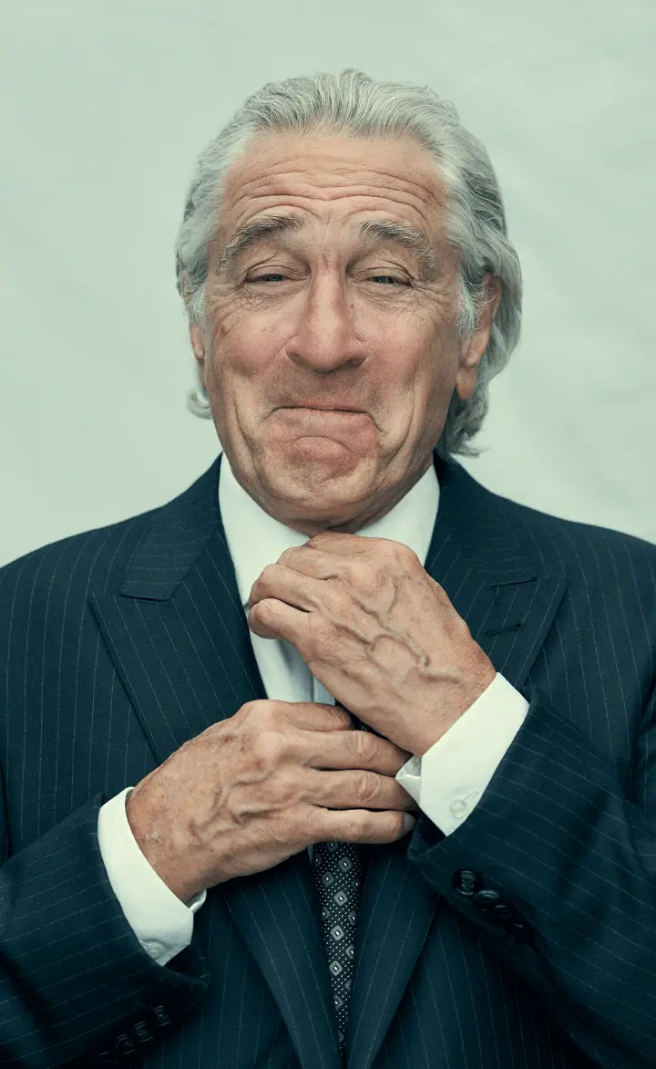 A portrait of Robert de Niro in a suit