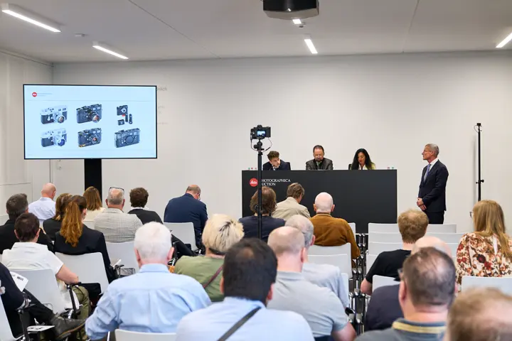 People bidding on a Leitz Photographica Auction.