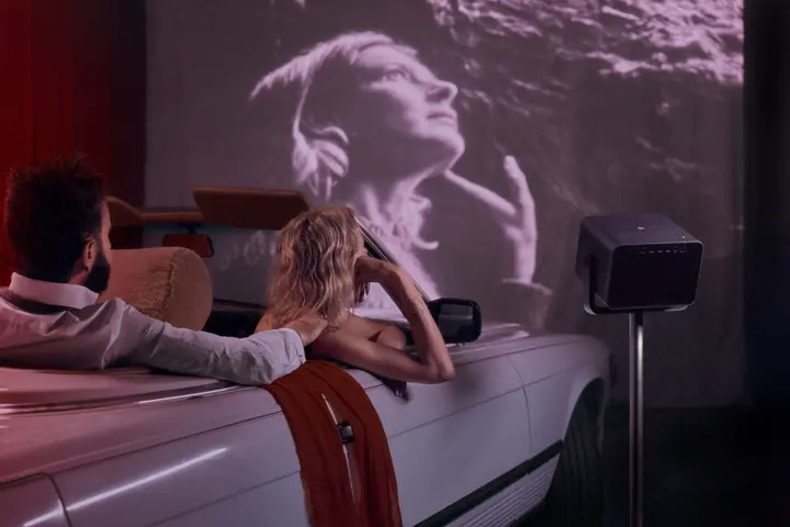 Couple watches film out of car