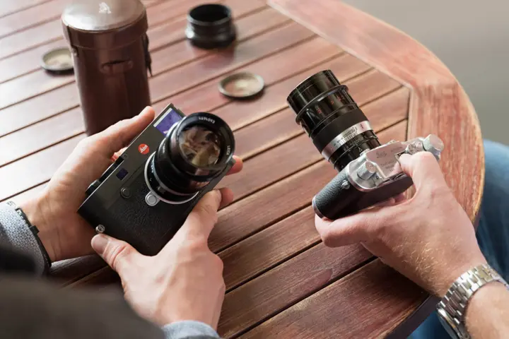 Two people are holding Leica M-System cameras