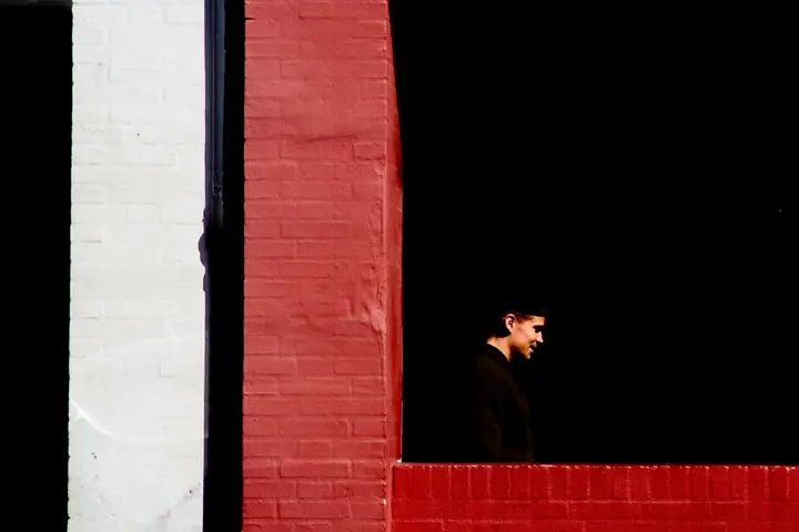 A man is standing in a window
