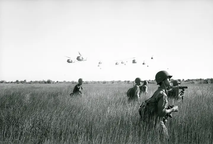 Soldiers and helicopters in the background