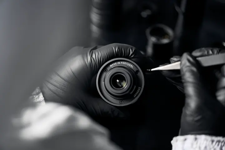 A Leica employee works on a Leica spotting scope