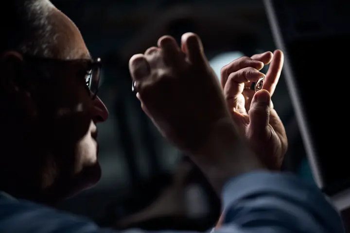 A Leica employee checks the lenses of a Leica spotting scope
