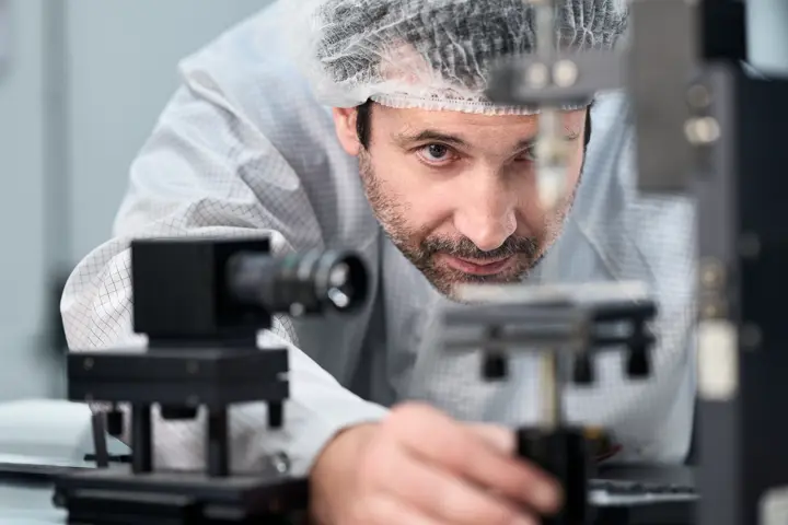 A Leica employee works on a Leica spotting scope
