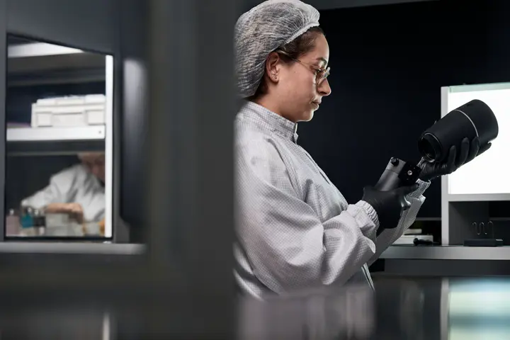 A Leica employee works on a Leica spotting scope