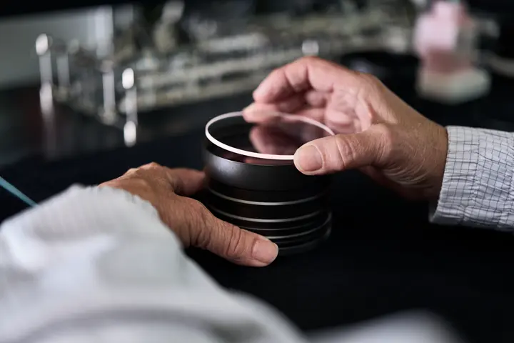 A Leica employee works on a Leica spotting scope