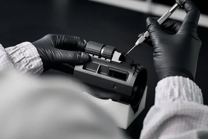 A Leica employee works on the dual fous of a Leica spotting scope
