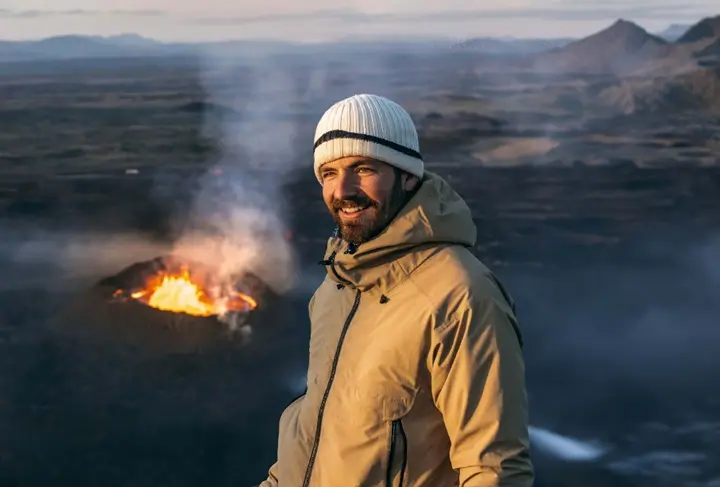 Image of Edwin Towler in front of a volcano and mountain range.