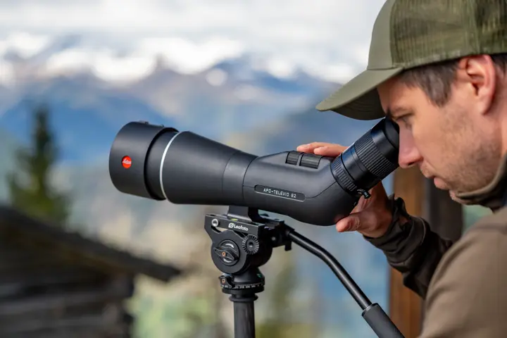 Man is looking through his Leica APO-Televid spotting scope