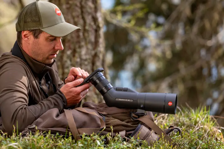 Man is digiscoping with his Televid spotting scope and smartphone